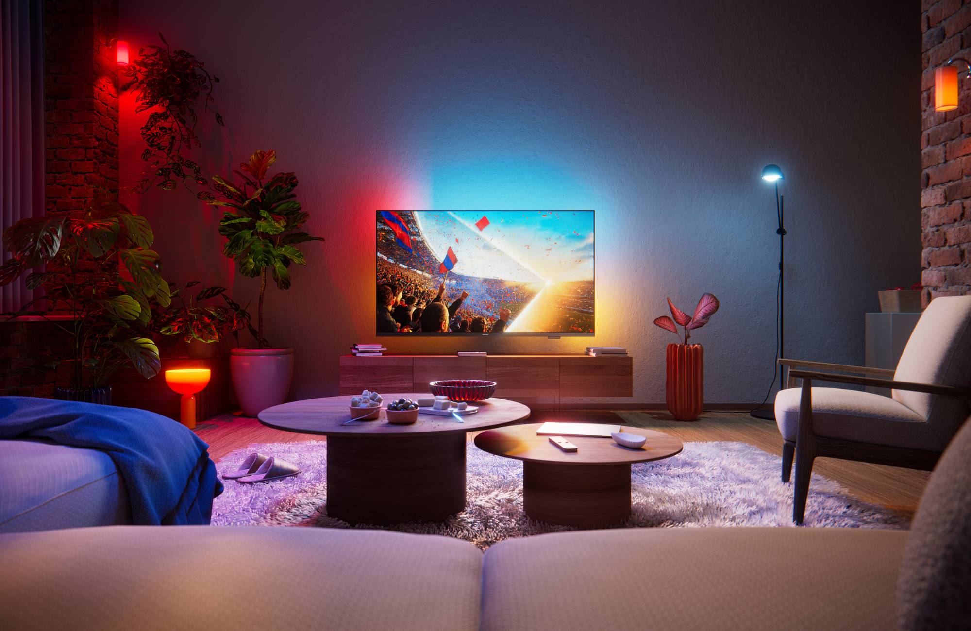 T&eacute;l&eacute;viseur Philips 50PUS8001 install&eacute; dans un salon moderne, diffusant un &eacute;v&eacute;nement sportif avec un &eacute;clairage d'ambiance color&eacute; synchronis&eacute;.